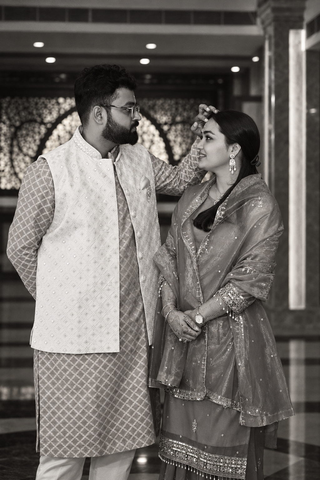 Srijan and Rashmi sharing a tender moment in a black and white portrait